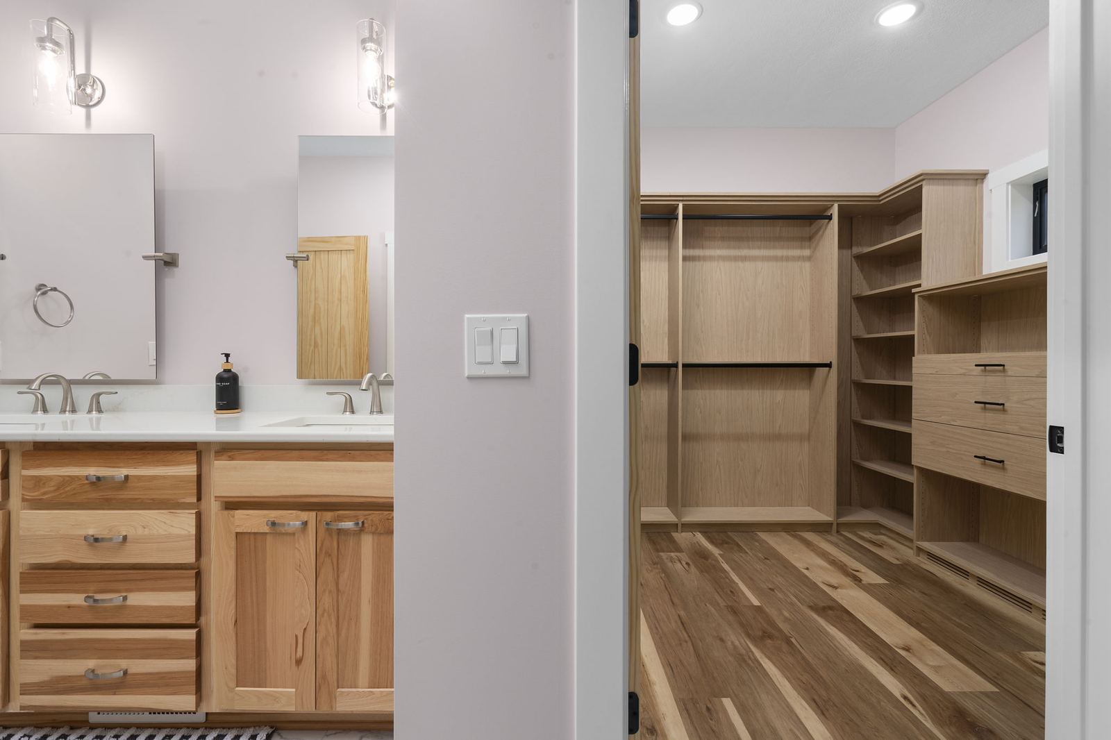 Walk-in closet in hickory with adjustable shelving, hanging rods and drawers
