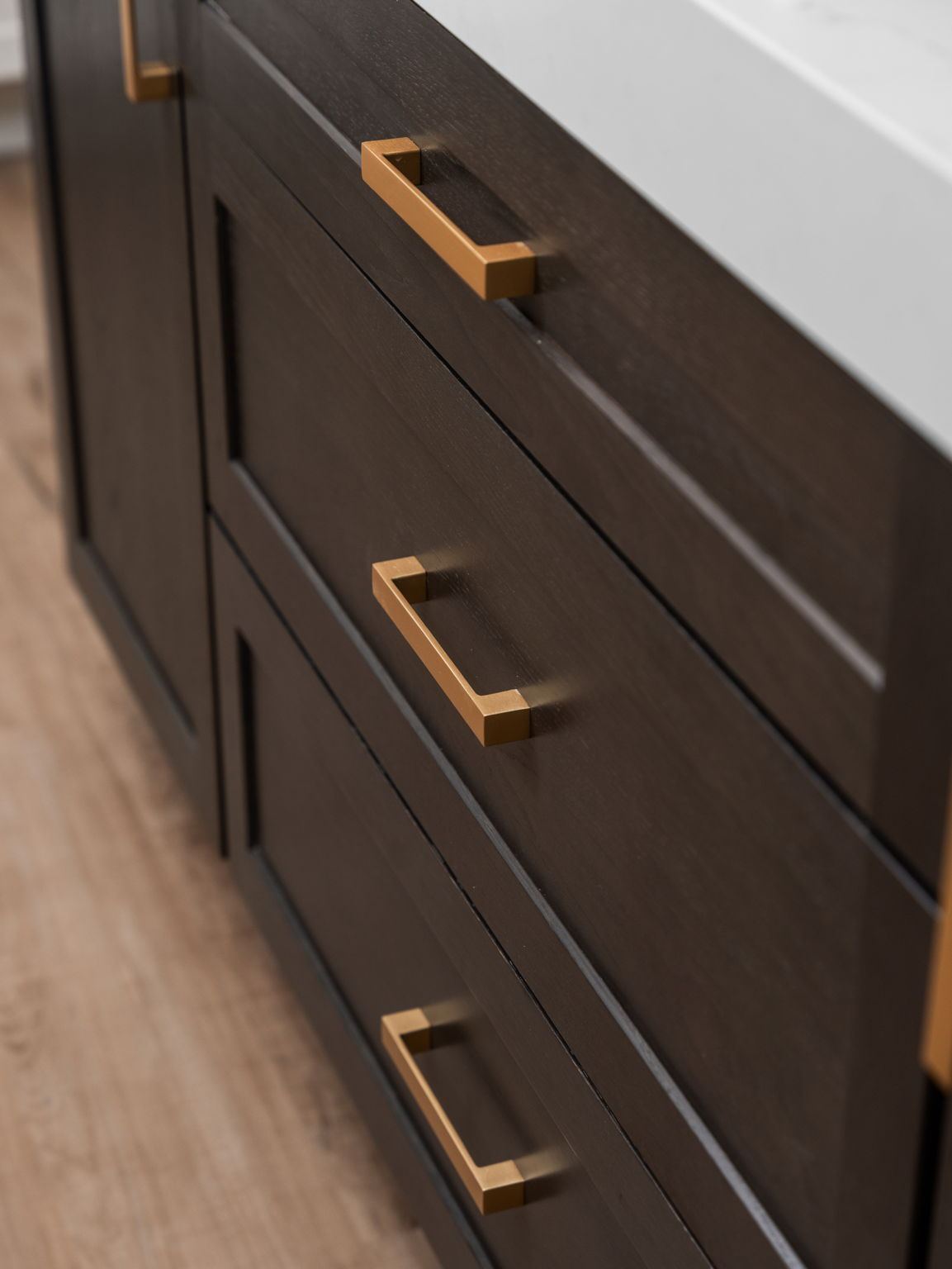 Dark stained drawer fronts with square brushed brass pulls