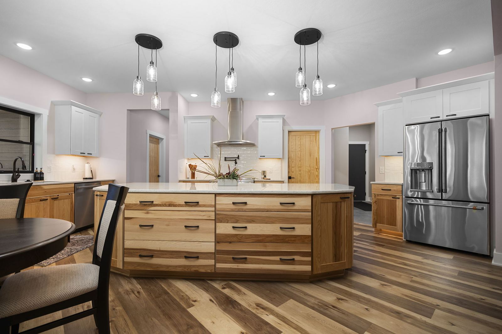 Hickory island kitchen with mason-jar pendants and wide-plank floors