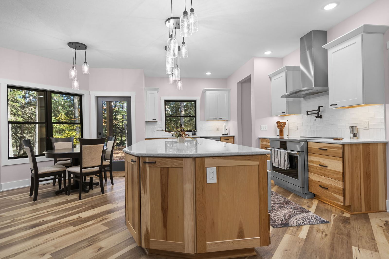 Hickory kitchen with a faceted island, quartz top and dining nook